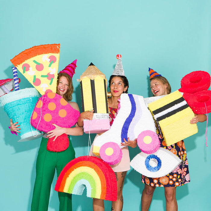Spread from Kitiya Palaskas' Pinata Party book featuring  group of people with pinatas